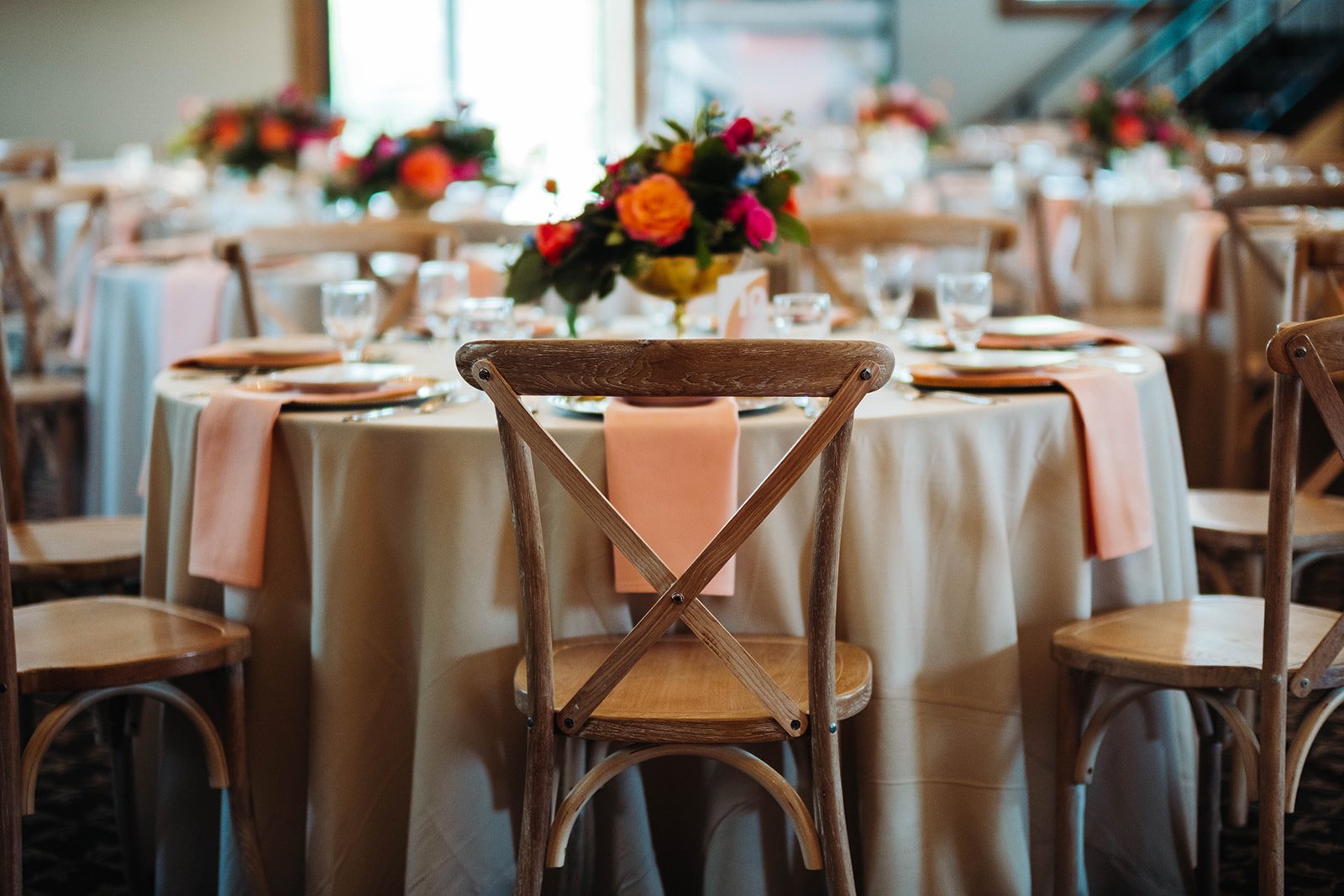 reception place setting with floral centerpieces that can be included in your wedding budget